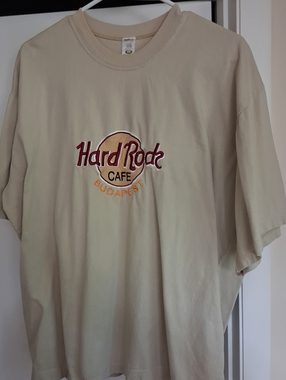 Hard Rock Cafe beige tee with red and gold logo